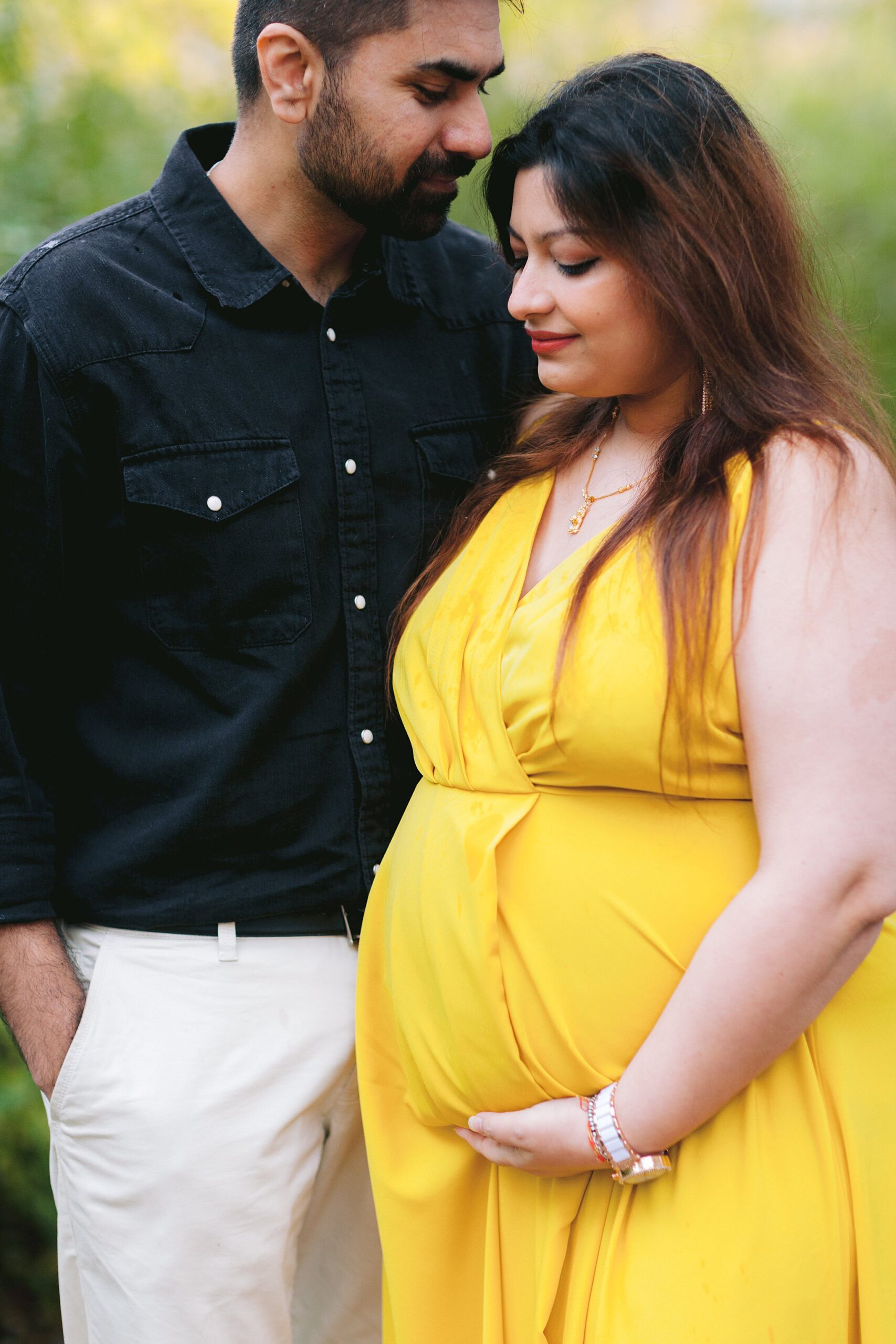 Expectant couple embraces in a romantic maternity photoshoot in Montreal's Old Port.