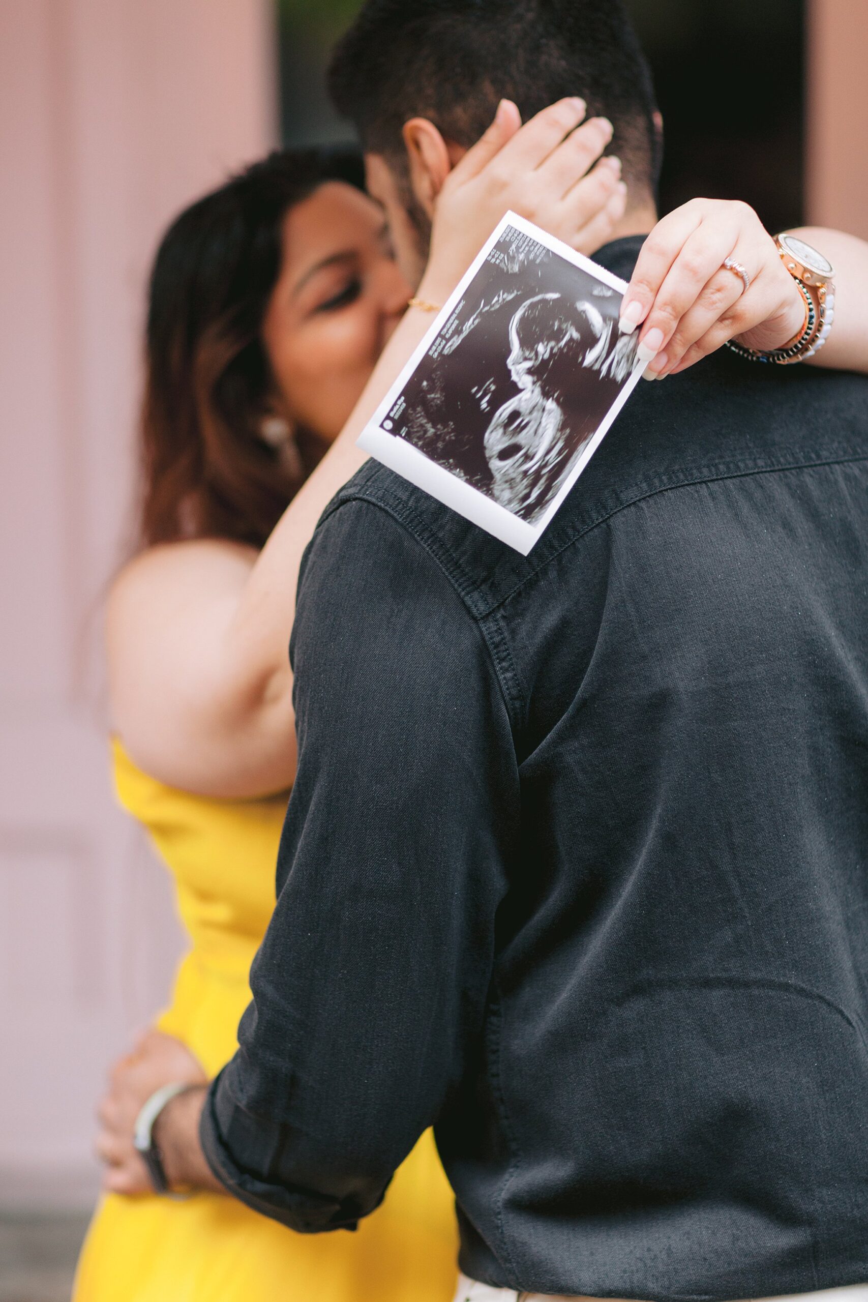 Candid moments of love and anticipation documented in a maternity shoot amid the timeless charm of Old Port, Montreal.
