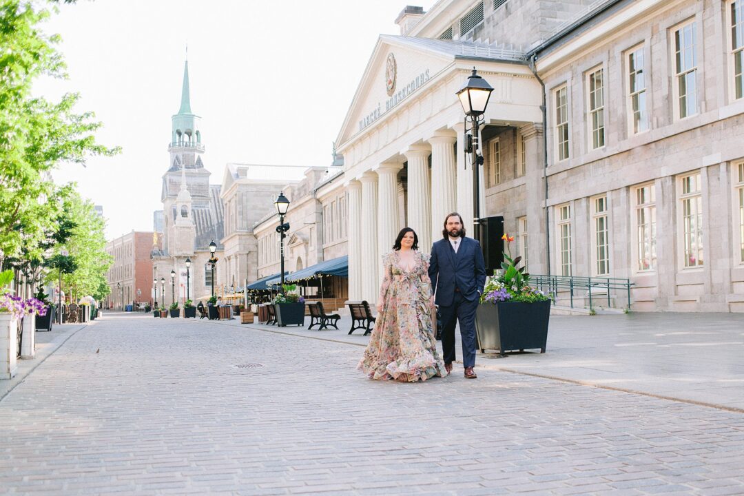 Couple walking down cobbled streets in Montreal