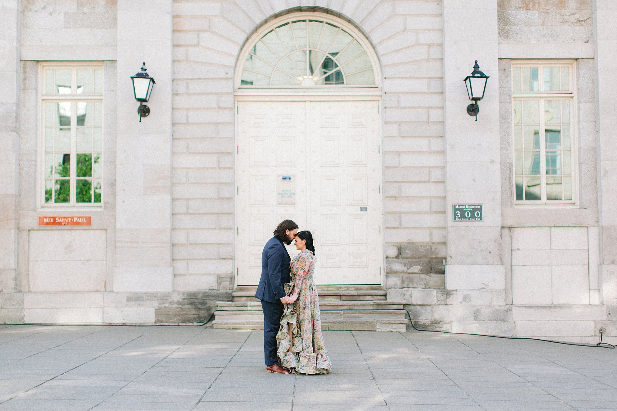 Newlyweds embracing near old Montreal architecture