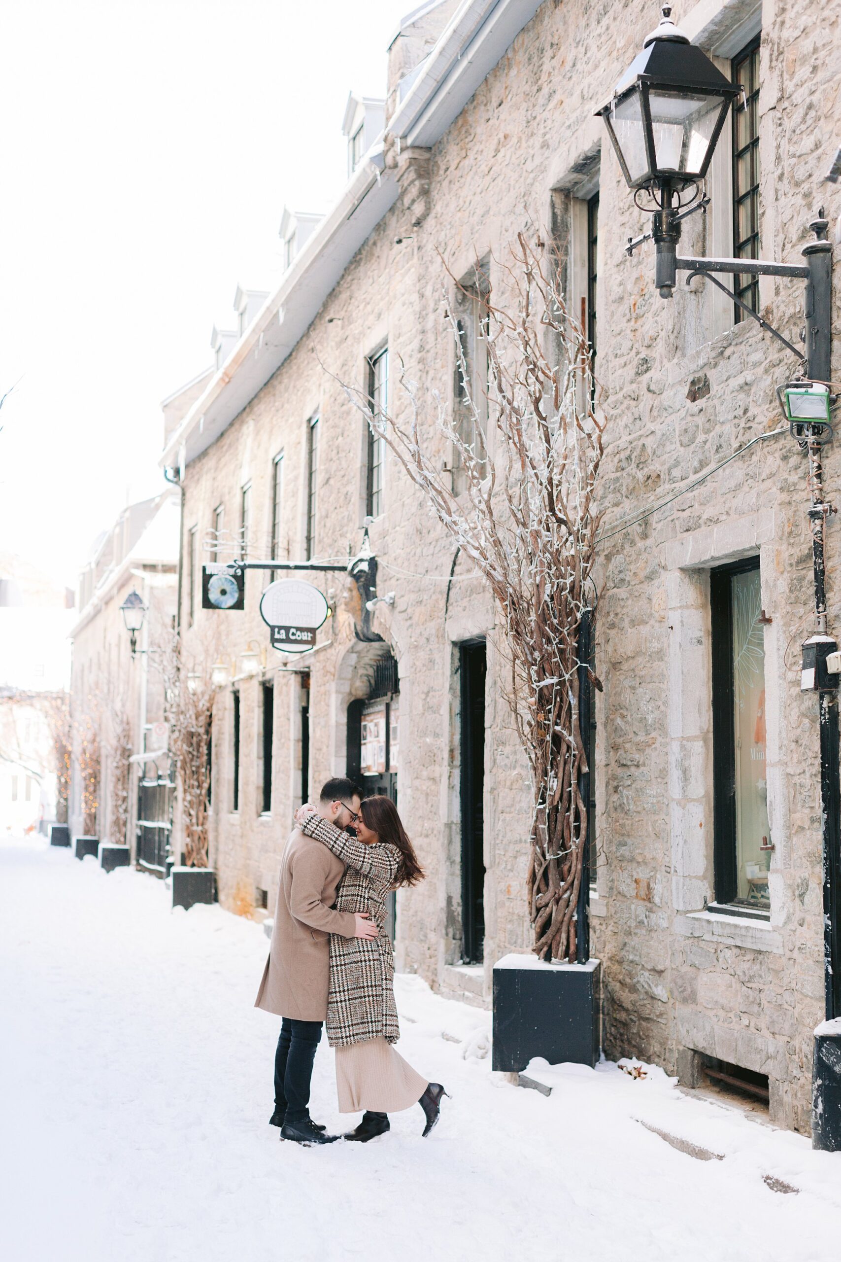 Quebec winter proposal shoot featuring a romantic moment in Old Port.