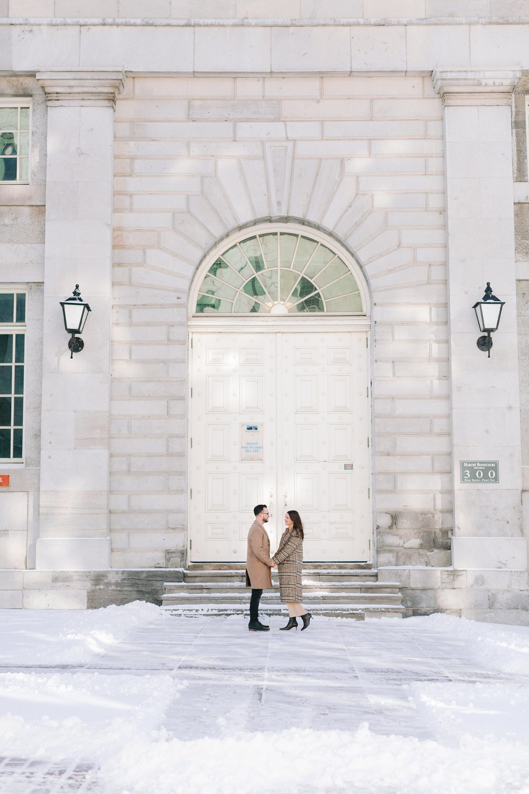 Candid engagement photography in the heart of Montreal during a winter snowfall.